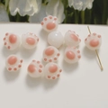 Macro view of cute 3D cat paw beads with pink pads and gold pin for DIY jewelry - 1 Piece / Pink