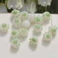 Macro detail of cute white and green 3D cat paw glass beads for DIY jewelry making - 1 Piece / Green