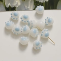 Macro view of white resin cat paw beads with blue print for DIY jewelry making - 1 Piece / Blue