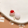 Detailed close-up of cute 3D cat paw glass beads for DIY jewelry with gold pin hardware - Red
