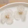 Detail of handcrafted woven crystal bead flower earrings with gold wire accents - White