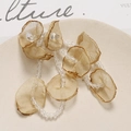 Detail of champagne mesh flower petals with crystal beads on a ceramic tray - Brown