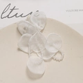 Macro detail of handmade white tulle flower petals with crystal beads for DIY jewelry - White