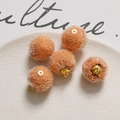 Detail of orange sequin pom-pom charms with gold rings for DIY jewelry making - Orange