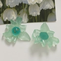 Macro detail of translucent green resin flower charms with gold foil core for DIY jewelry - Pale Green