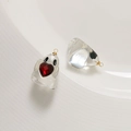 Macro shot of clear resin ghost pendants with red heart gemstones for jewelry making - Transparent + Red Heart