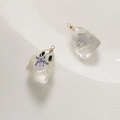 Close-up of translucent ghost charms with a purple glitter star and gold metal rings - Transparent White + Star