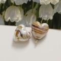 Detail of heart-shaped marble beads with caramel ink ripple pattern and golden pin - 1 Piece / Coffee