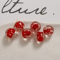 Macro view of 12mm luminous glass beads with red floral accents in a white dish - 12mm (1 Piece/Pack) / Clear
