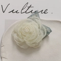 Close-up of handmade cream tulle camellia flower with grey-blue mesh leaves and beads - Off White