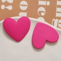 Macro shot of matte magenta resin heart charms for DIY jewelry making and hair accessories - Rose Red