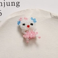 Detail of handmade beaded cat charm with pink dress and blue earrings on stone tray - Blue Ear Style