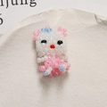 Close-up of handmade pink and white beaded cat pendant on textured stone background - Pink Ear Style