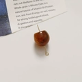 Detailed view of amber fruit-shaped DIY bead with golden metal loop for jewelry making - Irregular Fruit Shape (B31-3-10) / 1 Piece / Amber