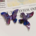 Macro detail of gradient leopard print acetate butterfly charms for jewelry making - Purple