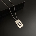 Titanium steel rectangle tag necklace featuring a cutout letter B in silver finish - Letter B
