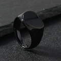 Minimalist black polished stainless steel signet ring on a textured slate background - Size 6 / Heart / Black
