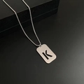 Silver-toned titanium steel necklace with a hollow-out letter K pendant on bead chain - Letter K
