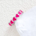 Silver ring with rose pink enamel heart patterns on a white textured background - Full Circle Heart Rose Silver Style (k-13)