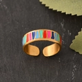 Adjustable gold stainless steel ring with colorful striped enamel on a stone surface - Colorful Stripes Gold Style (k-48)