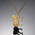 Macro detail of golden butterfly pendant with hollow wing and initial letter C charm - Letter C / Silver