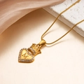 Golden heart necklace with crown detail and letter M engraving on snake chain - M