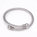 Silver twisted cable stainless steel bangle featuring smooth metal ball ends in a minimalist style - Steel