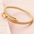 Golden twisted cable nail cuff bracelet in stainless steel featuring a sleek punk style - Gold