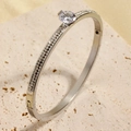 Polished silver titanium steel bangle with oval main stone and pave-set dark crystals - Steel