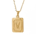 Macro detail of 18K gold plated stainless steel square pendant with letter V engraving - Letter V