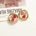 Macro detail of handmade resin earrings with red dried flowers and gold metal frames - Red Dried Flower Gold Irregular Frame Style