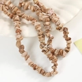 Macro detail of natural irregular marble beads on a white ceramic plate for DIY jewelry - Approx 270 Pcs/Strand / Warm Beige Texture (0801)