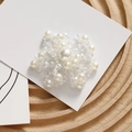 Detailed close-up of a handcrafted star-shaped charm with faux pearls and crystal beads - Flower Motif Style