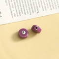 Detailed view of purple evil eye glass beads for DIY jewelry with glossy finish - Purple Round / 1 Piece
