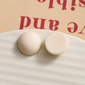 Macro detail of 15.5mm matte cream resin domes for DIY jewelry making and accessories - Milky White Round