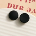 Detailed close-up of vintage black matte and semi-gloss resin round stud earrings - Round Black
