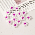 Detail view of 12mm woven pearl acrylic flower beads with pink crystal center for DIY jewelry - Rose Red