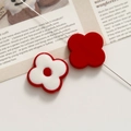 Macro view of flower acrylic beads with central hole for DIY jewelry making - Red