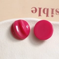Macro shot of rose pink resin semi-circle charms with smooth and spiral texture details - Rose Red