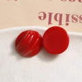 Macro detail of red resin semi-circle earrings with smooth and spiral texture surfaces - Bright Red