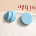 Macro shot of light blue resin semi-circle charms with smooth and spiral textured finish - Light Blue