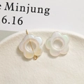 Macro detail of iridescent white resin flower charm with gold pin for DIY jewelry making - Hollow Flower / AB White
