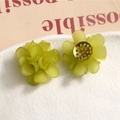 Detail of matte green floral acrylic earrings with gold center on a white textured plate - Light Green