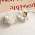 Detail of matte white flower resin earrings with layered petals and gold metal base - Pearl White