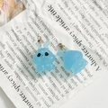 Close-up of translucent light blue resin bunny pendants with silver glitter and gold loops - Pale Blue Glitter Rabbit (5)