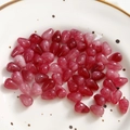 Macro shot of red marbled teardrop beads for jewelry making displayed on a ceramic plate - 1 Piece / Rose Red
