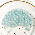 Macro shot of light blue translucent teardrop stones with holes for DIY jewelry - 1 Piece/Pack / Light Blue