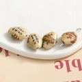 Macro shot of oval ceramic beads featuring traditional Chinese calligraphy and floral patterns - Style 1 Calligraphy Floral Oval Bead / 16x12mm