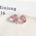Close-up of matte pink frosted glass heart beads with painted rose patterns for DIY jewelry - Heart (25#)