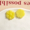 Macro shot of matte yellow resin sunflower charms for DIY hair accessories and crafts - Yellow